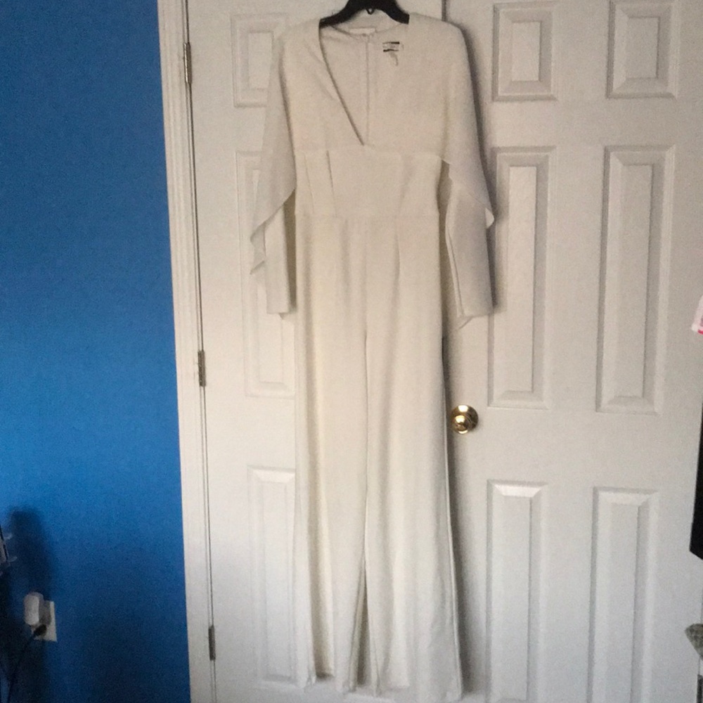 White jumpsuit with chiffon cape